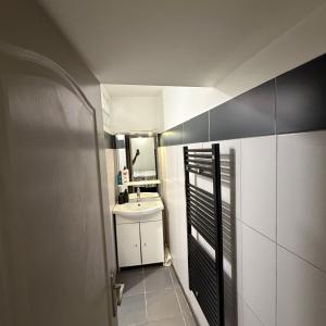a small bathroom with a sink and a mirror at Appartement centre ville in Ajaccio