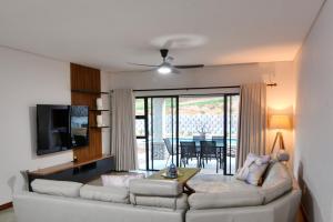 a living room with a white couch and a table at Solana Villa in Hazyview