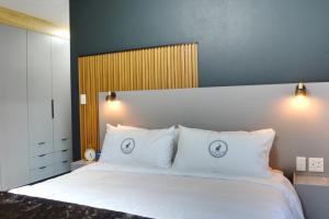 a bedroom with a large white bed with white pillows at Solana Villa in Hazyview +33 photos
