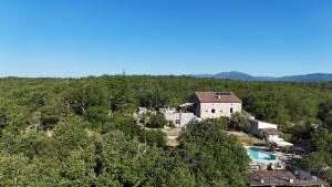 an aerial view of a house in the forest at Les Dolines in Balazuc