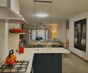 a kitchen and living room with an elephant on the wall at Solana Villa in Hazyview
