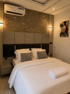 a hotel room with two beds with white sheets at Ileero Homes The Beachfront in Lekki +37 photos