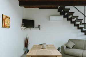 a living room with a couch and a table at Aura Residence in San Biagio