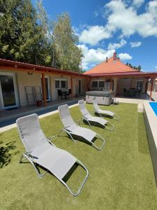 a group of lawn chairs sitting on a yard at Borti Apartman in Zamárdi