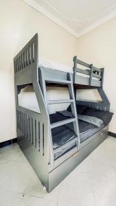two bunk beds in a room at Bwebajja Hub in Bwebajja
