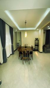 a dining room with a wooden table and chairs at Bwebajja Hub in Bwebajja