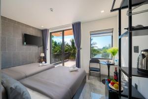 a hotel room with a bed and a balcony at Kikihao Homestay Hội An Near Tra Que Village in Hoi An