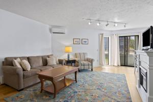 a living room with a couch and a table at 110 Pointes North Inn in Charlevoix