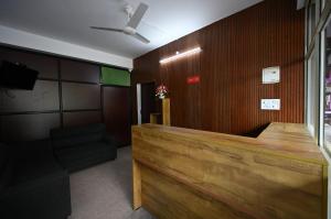 a waiting room with a wood paneled wall at Norwegian Guest House in Anachal