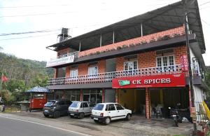 a building with cars parked in front of it at Norwegian Guest House in Anachal