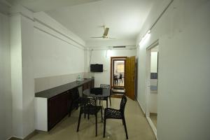 a kitchen and dining room with a table and chairs at Norwegian Guest House in Anachal