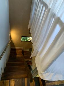 a stairway with a white curtain and some stairs at Casa mussambé in Sao Jorge
