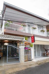a building with a balcony and a store with flowers at Dốc Phố Home - Dalat Homestay in Xuan An