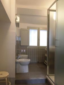 a bathroom with a toilet and a sink at Loft with a ducal view in Urbino