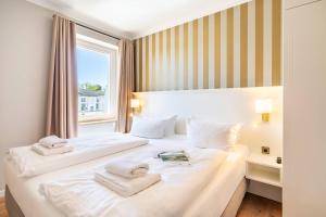 a hotel room with two beds with towels on them at SEETELHOTEL Ostseeresidenz Ahlbeck in Ahlbeck +43 photos