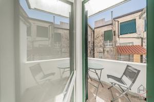 a view from a window of a balcony with a table and chairs at Behind the Sea - Parcheggio gratis - mare 5 min in Noli