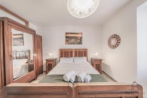 a bedroom with a large bed with two pillows on it at Behind the Sea - Parcheggio gratis - mare 5 min in Noli +18 photos