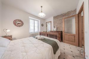 a bedroom with a large white bed and a bathroom at Behind the Sea - Parcheggio gratis - mare 5 min in Noli