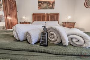 a bed with a bottle of alcohol on top of it at Behind the Sea - Parcheggio gratis - mare 5 min in Noli