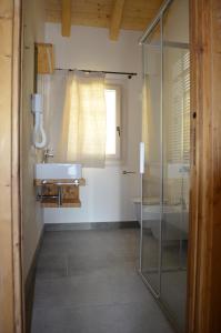 a bathroom with a glass shower and a sink at BROCHETA GUEST HOUSE in Belluno