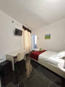 a bedroom with a bed and a desk and a table at Hotel Solferino in Brescia