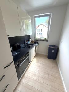 a kitchen with a sink and a counter top at Boutique Apartment mit Balkon, Küche, Zentral, HDZ, BALI THERME, GOP in Bad Oeynhausen