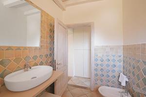 a bathroom with a sink and a toilet at Appartamento il Caracolo a Cala Francese in La Maddalena +7 photos