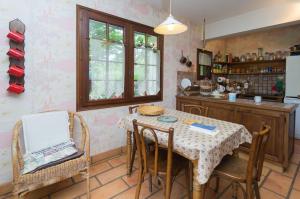 a kitchen with a table and chairs in a room at Gite de Loche in Quet-en-Beaumont +19 photos