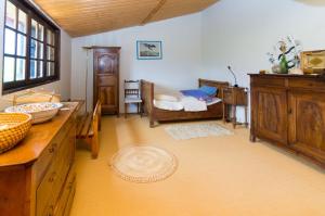 a bathroom with a sink and a bed in a room at Gite de Loche in Quet-en-Beaumont