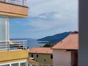 a view of the ocean from a balcony of a building at Lovely apartment Branko Rabac with balcony and parking in Rabac