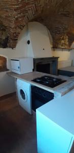 a kitchen with a stove and a stove top oven at Il Nido di Ory in Clusane sul Lago +22 photos