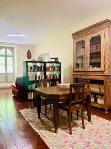a living room with a wooden table and chairs at Château Lagelouse in Mimbaste +27 photos