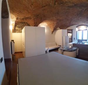 a kitchen and living room with a white refrigerator at Il Nido di Ory in Clusane sul Lago
