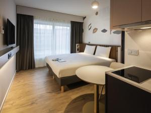 a hotel room with a bed and a table at Adagio access Brussels Delta in Brussels +71 photos