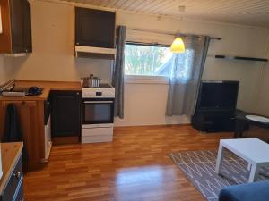 a small kitchen with a stove and a window at Modern Arctic Apartment in Tromsø