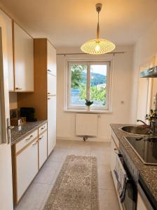 a kitchen with a window and a sink and a counter at Helena City Apartment in Leoben