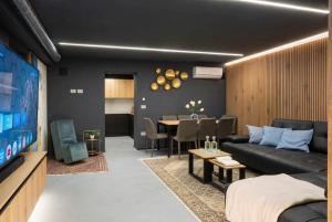 a living room with a couch and a table at VILLA OXA 12&2, Emma Villas in Imola
