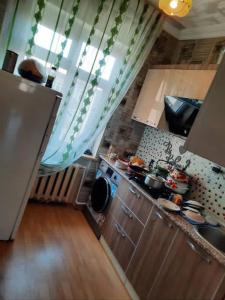 a small kitchen with a sink and a stove at Evv in Naxçıvan