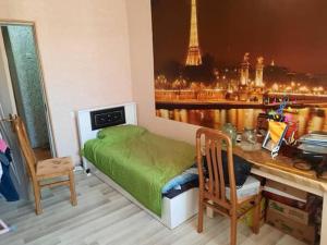 a bedroom with a bed and a desk with a view at Evv in Naxçıvan
