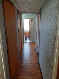 an empty hallway with a table and a chair at Evv in Naxçıvan
