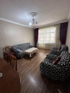 a living room with two beds and a table at Evv in Naxçıvan