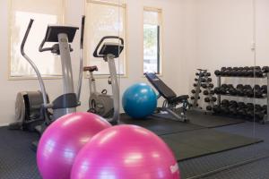 a gym with exercise balls and exercise bikes at Heartland Hotel Auckland Airport in Auckland