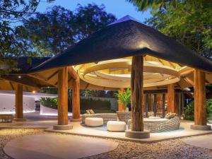 a large pavilion with chairs and a table at Mercure Rayong Lomtalay Villas & Resort in Mae Pim
