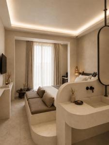 a hotel room with a bed and a bath tub at RHODEA Mar in Faliraki