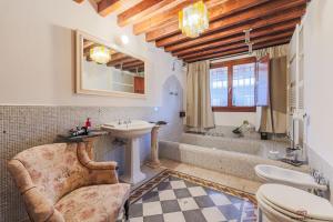 a bathroom with a sink and a tub and a toilet at VM Boutique in Castiglione di Ravenna +28 photos