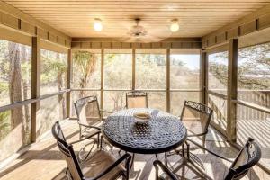 a dining room with a table and chairs on a porch at Inlet Cove 94 in Kiawah Island