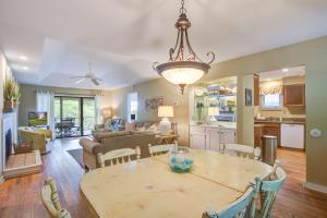 a dining room and living room with a table and chairs at Inlet Cove 94 in Kiawah Island
