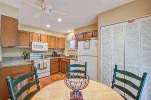 a kitchen with a table and chairs and a refrigerator at Inlet Cove 94 in Kiawah Island +22 photos