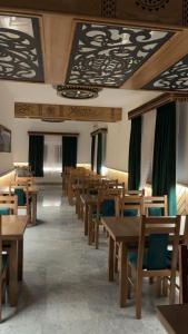 a dining room with wooden tables and chairs at DW u Rafała i Joanny in Białka Tatrzańska