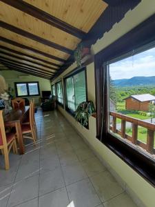 a living room with a table and a window at Guesthouse Pavličić in Drežnik Grad +51 photos